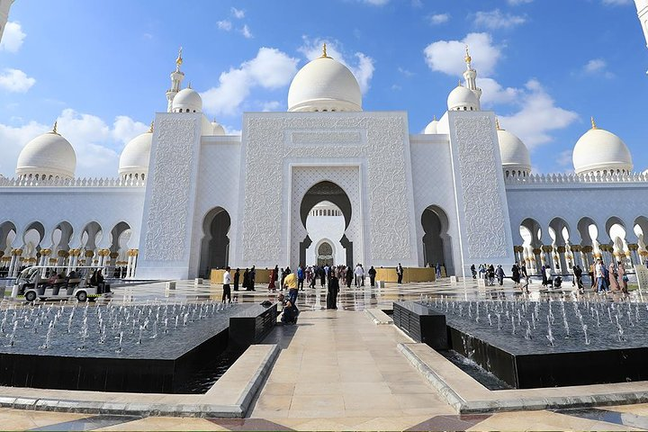 Explore the stunning design of the Grand Mosque where intricate details meet serene water features offering an unforgettable glimpse into Abu Dhabi's rich cultural heritage and architectural beauty.